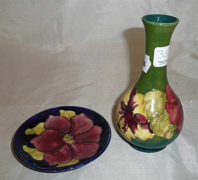 Lot 353 - A Walter Moorcroft 'Hibiscus' vase, on a green ground, printed label, and a Walter Moorcroft...