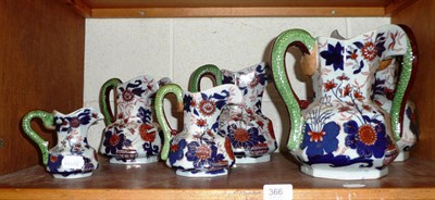 Lot 366 - A set of six modern graduated iron stone jugs with blue, red and gilded decoration