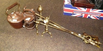 Lot 388 - A pair of brass fire dogs, a three piece fire companion set, a copper kettle and a watering can