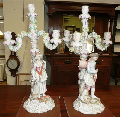 Lot 407 - A pair of Volkstedt candelabra with figures of peasants and flower encrusted