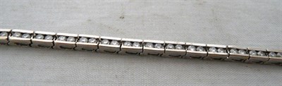 Lot 428 - A Diamond Bracelet, pairs of round brilliant cut diamonds in articulated white bar settings,...