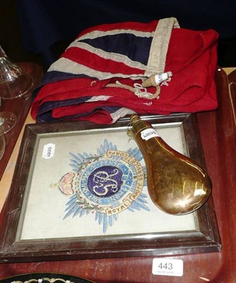 Lot 443 - A regimental sampler, powder flask and a sign