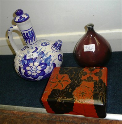 Lot 491 - Red glazed bottle vase, lacquered box and cover, blue and white modern pottery ewer (3)