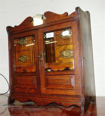 Lot 506 - An oak laced smoker's cabinet with inscribed plaque