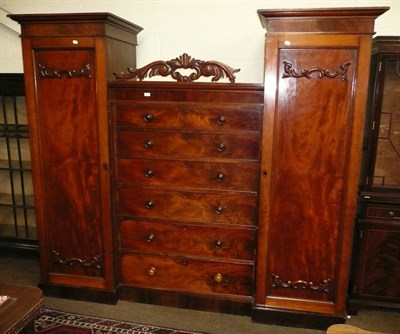 Lot 515 - A Victorian mahogany two door wardrobe with a chest of drawers centre section