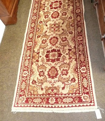 Lot 525 - Two similar cream and red ground pattern runners