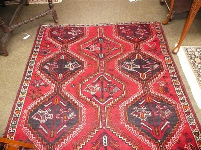 Lot 539 - Kashgai rug South West Persia The tomato field with three columns of stepped medallions enclosed by