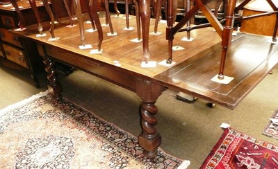 Lot 542 - A large oak drawer leaf table on barley twist legs