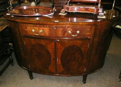 Lot 563 - A reproduction bow fronted sideboard