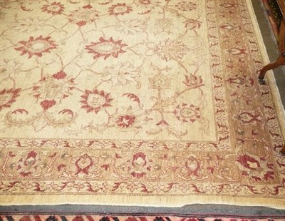 Lot 566 - A cream, brown and red patterned wool carpet