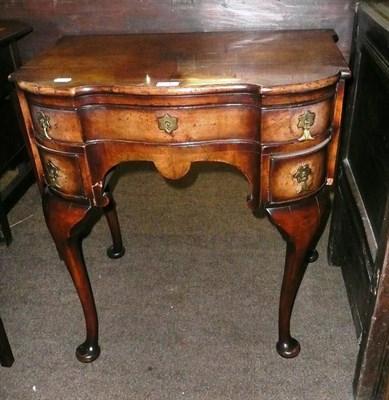 Lot 571 - A reproduction walnut side table of two short, and one long drawer