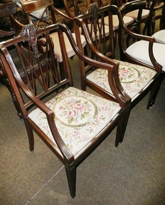 Lot 599 - A pair of Edwardian mahogany open arm chairs with wool work drop in seats