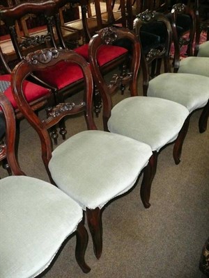 Lot 604 - A set of six Victorian mahogany balloon back dining chairs with carved backs