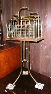 Lot 638 - A oak and brass mounted magazine rack on tripod stand