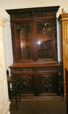 Lot 646 - A Victorian carved oak book case over cupboard