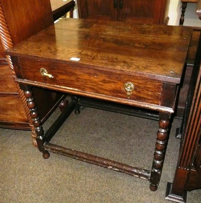 Lot 658 - An oak single draw side table on barley twist legs (a.f.)