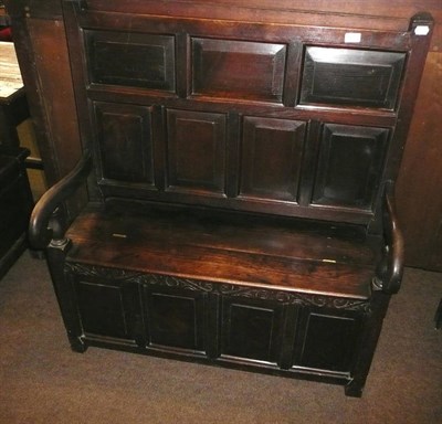 Lot 663 - A small oak panel back settle