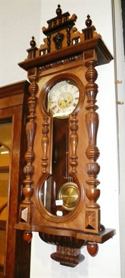 Lot 667 - A walnut striking wall clock