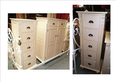 Lot 712 - Two modern cream painted tall boy chests of five drawers and a matching cupboard