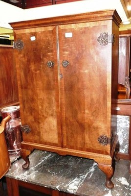 Lot 757 - A reproduction walnut two door cabinet