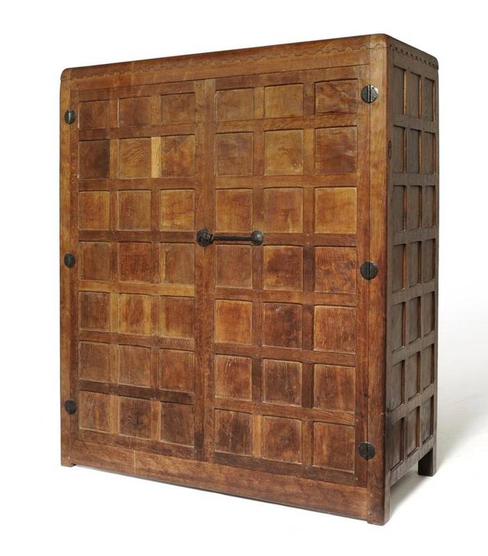 Lot 727 - A Robert  "Mouseman " Thompson Panelled Oak Wardrobe, circa 1930's, with castellated top above...