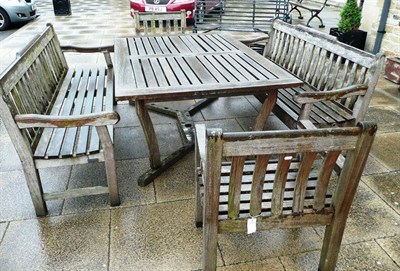 Lot 823 - Garden furniture comprising: a wooden table with two benches and two chairs