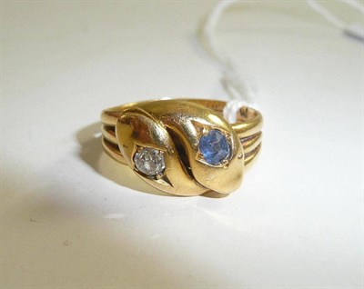 Lot 18 - An 18ct gold double snake head ring set with diamond and sapphire