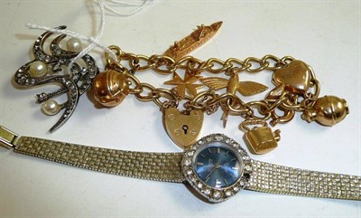 Lot 34 - A charm bracelet hung with eight charms, a lady's Everite wristwatch and a paste and simulated...