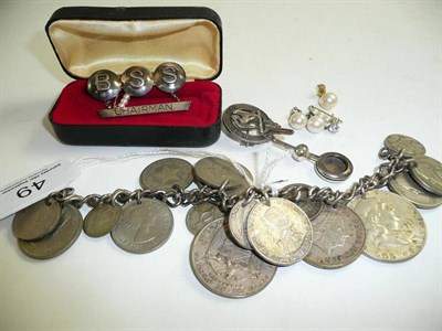 Lot 49 - A small quantity of jewellery, including a coin bracelet, a silver brooch, a silver napkin...