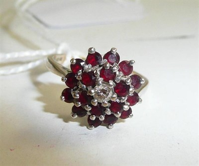 Lot 55 - An 18ct white gold diamond and red stone cluster ring