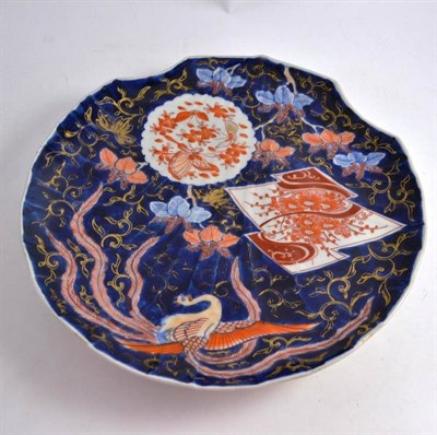 Lot 76 - A Japanese Imari shell shaped charger, decorated with a phoenix on a cobalt ground and...
