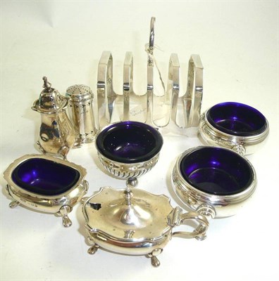 Lot 151 - A silver toast rack, two cauldron salts, two others, two pepperettes and a mustard