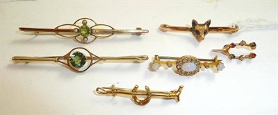 Lot 152 - Two peridot brooches, an opal and diamond brooch, assorted brooches