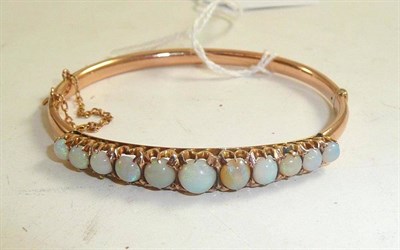 Lot 178 - An opal set bangle