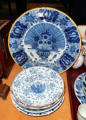 Lot 243 - Five English Delft plates with floral decoration and a Continental Delft charger