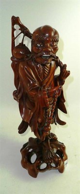 Lot 254 - A carved hardwood figure of an elderly man