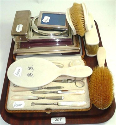 Lot 257 - Cased manicure set with mother of pearl handles, silver lidded box, a brush set and four silver...