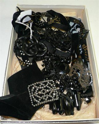 Lot 330 - A box of assorted jet and French jet jewellery and three black banded bracelets