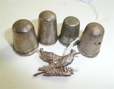 Lot 343 - Four silver thimbles and a silver pheasant brooch