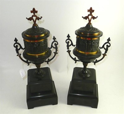 Lot 377 - Pair of twin handled pedestal urns on black slate bases (part of a garniture)