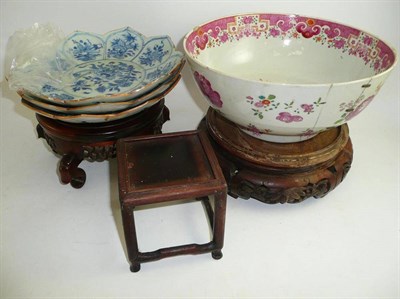 Lot 380 - A Chinese famille rose bowl, three 18th century shaped dishes and wood stands