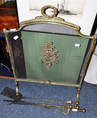 Lot 414 - A pair of brass fire dogs, spark guard and a three piece fire companion set