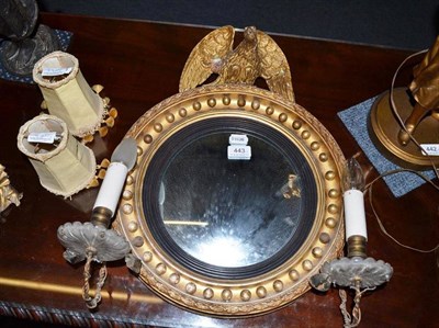 Lot 443 - A small Regency convex mirror with eagle pediment and two candle brackets