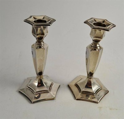 Lot 460 - Pair of loaded silver candlesticks