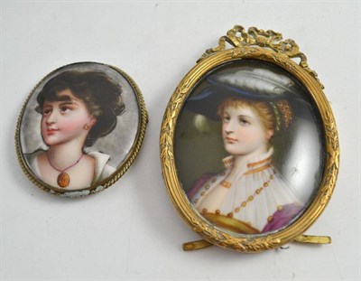 Lot 469 - A painted porcelain plaque of a woman in a hat, in gilt metal frame, and another similar (2)