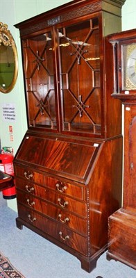 Lot 564 - A reproduction mahogany bureau bookcase