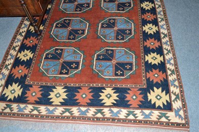 Lot 613 - Afghan rug North Afghanistan, the brick red field with two rows of serrated guls enclosed by narrow