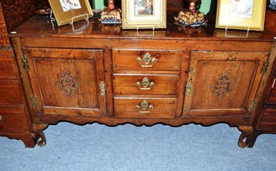 Lot 624 - A carved oak sideboard with an arrangement of two panel doors and three narrow drawers