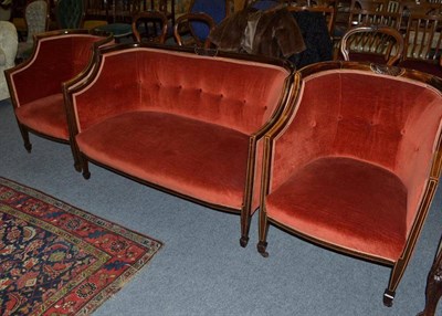 Lot 637 - An Edwardian red upholstered settee with ivory line inlay and two matching tub chairs