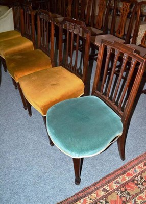 Lot 645 - A set of four mahogany dining chairs on spade feet and another similar